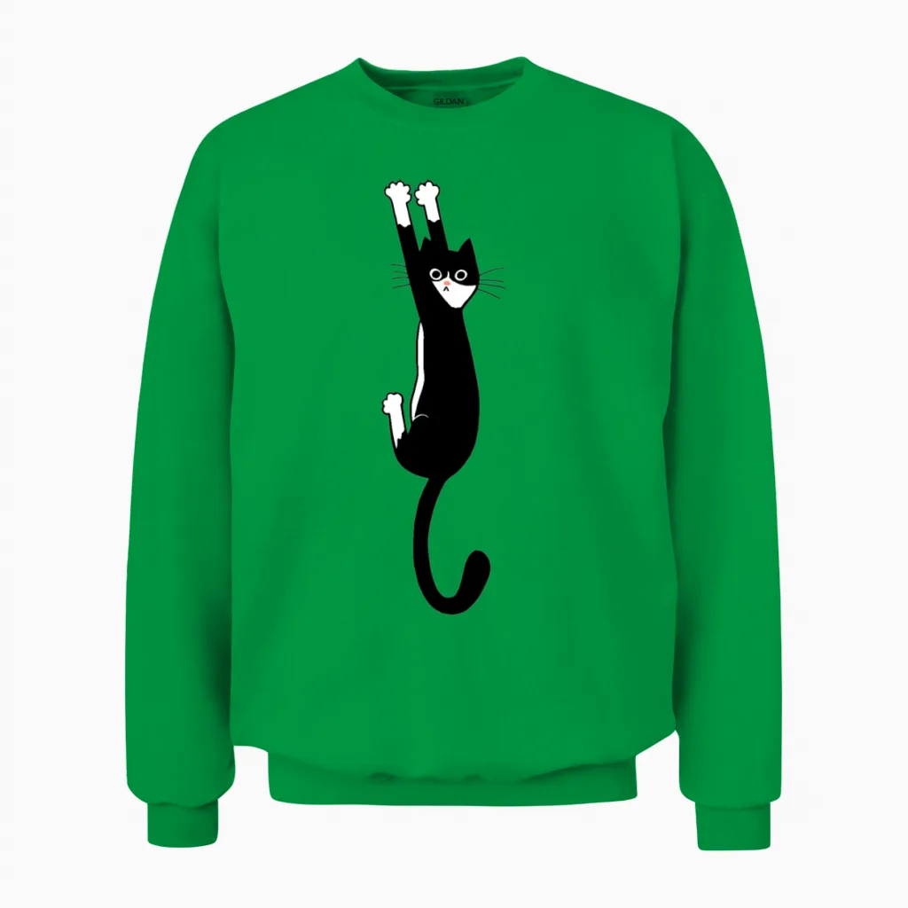 Black and White Cat Hanging On Unisex Sweatshirt in Irish Green